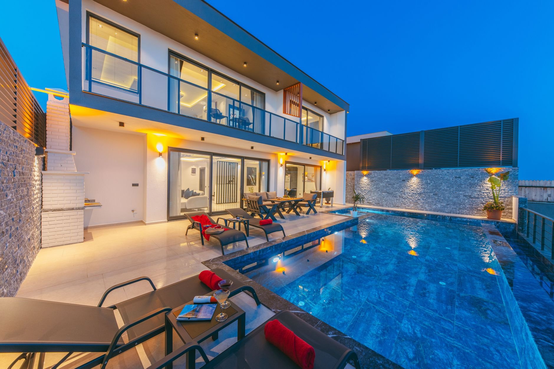 A tranquil evening at a modern luxury villa with a stunning poolside ambiance